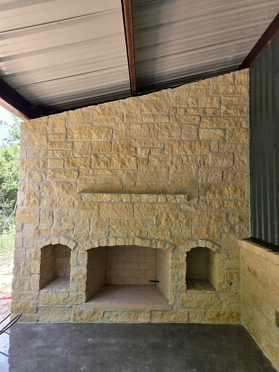 Limestone fireplace with arched wood niches